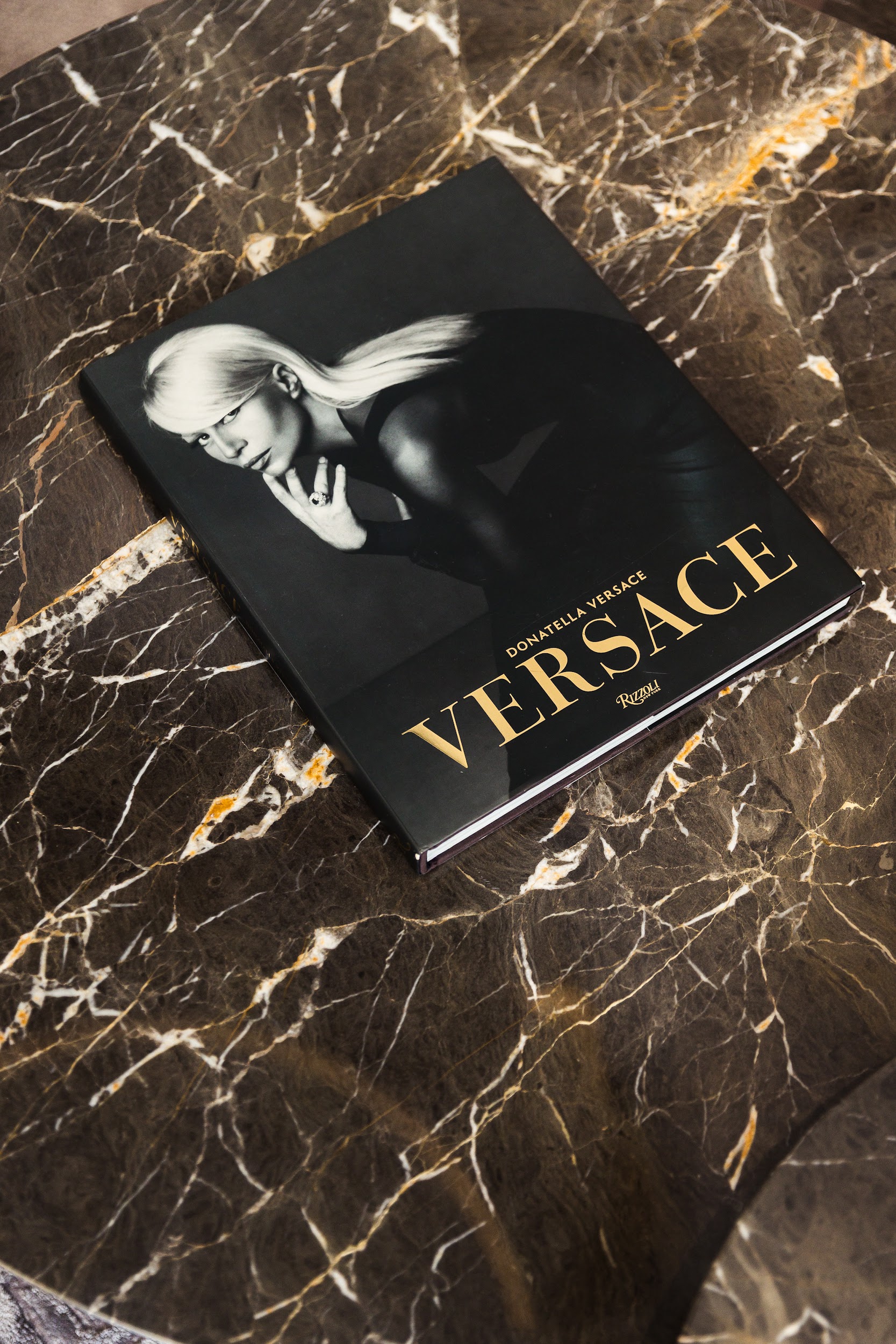 A Versace book on a marble table in the showroom