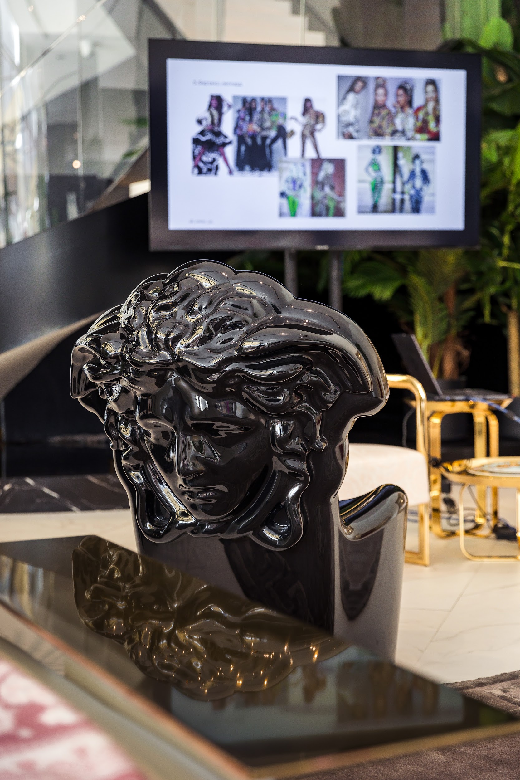 The Versace Medusa against slides about the house's collections